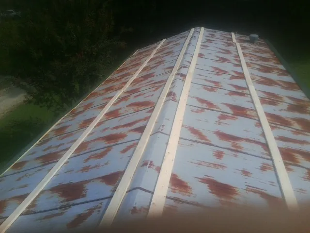 Rusted metal roof panels with new wood purlins before replacement — Storm Damage Roof Repair in Ryderwood by Roofing Brothers